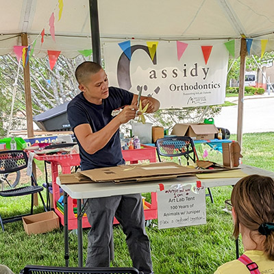Artist Juniper Tangpuz leading an activity in the Art Lab Outdoors tent