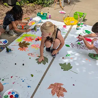 Kids making art outside during the Mulvane's Summer Camp